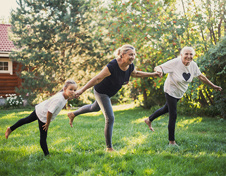 Multi-generational women exercising together outdoors, promoting functional fitness and healthy aging
